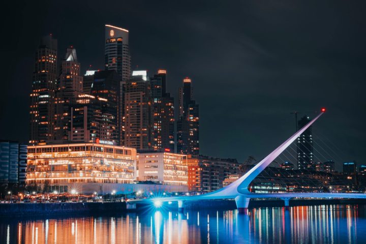 a large body of water with a city in the night sky